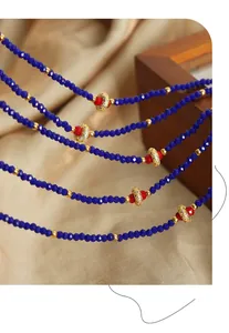 Close-up of vintage multi-layer necklace with dark blue faceted beads and gold accents
