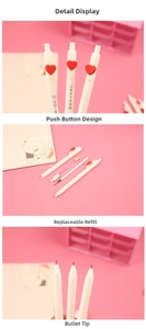 Detail of white retractable gel pen with red heart clip and bullet nib design