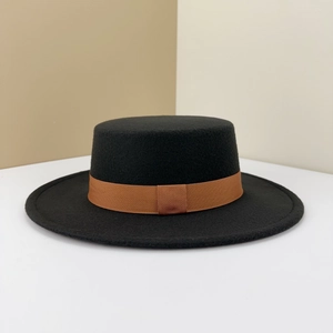 Detailed close-up of a black flat-top boater hat with a textured brown ribbon band