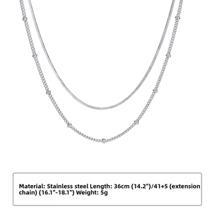 Detailed view of silver double-layer stainless steel snake chain and beaded satellite necklace