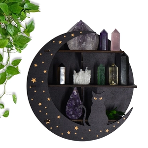 Black crescent moon shelf with star cutouts and cat silhouette displaying crystals