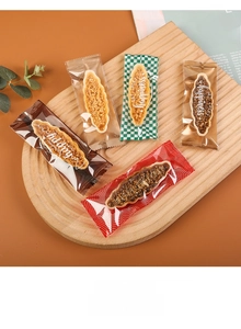 Detail of assorted nut tart cookies in transparent heat-sealed packaging on a wooden tray