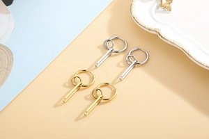 Detail of multi-layer geometric drop earrings in gold and silver stainless steel finish