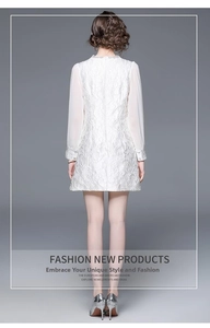 Back view of white lace dress with sheer tulle sleeves and floral jacquard texture