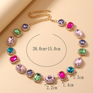Detail view of gold clavicle necklace with multi-colored gems and size measurements