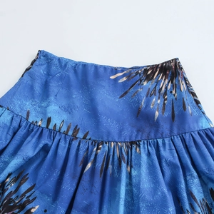 Blue holiday print skirt set featuring pleated waist detail and abstract feather pattern