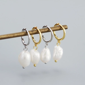 Close-up of minimalist S925 silver hoop earrings with irregular Baroque freshwater pearls
