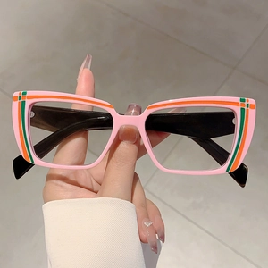 Detail of pink rectangular eyewear with colorful striped accents and black temple arms