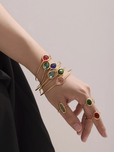 Detailed view of 18k gold-plated bangles set with colorful teardrop-shaped Czech glass