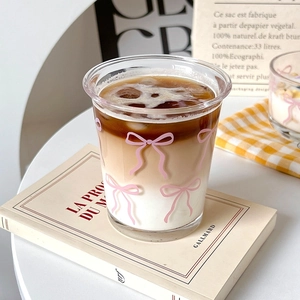 Ins style glass cup with pink bow pattern featuring a layered cold brew coffee drink