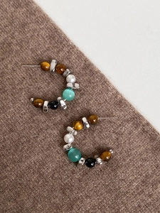 Detail of S925 sterling silver stamp on C-shaped beaded tiger eye earrings