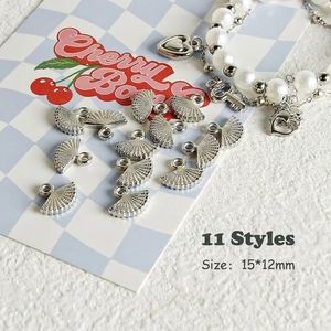 Macro detail of 15x12mm silver fan pendants for DIY jewelry and Y2K necklace making