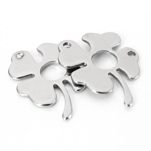 Macro shot of two silver four-leaf clover charms made of polished stainless steel metal