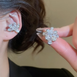 Detailed view of silver flower ear cuff with sparkling marquise cut cubic zirconia