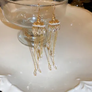 Elegant gold tassel earrings with artificial crystals in a vintage palace style design