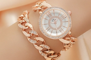 Close-up of rose gold crystal quartz watch and matching rhinestone chain bracelet set