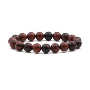 Detailed macro view of 10mm natural red and black marbled stone beads on an elastic bracelet
