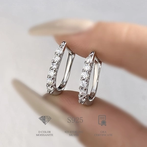Macro shot of S925 sterling silver U-shaped hoop earrings with D color Moissanite stones