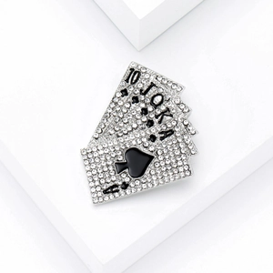 Silver plated royal flush poker cards brooch with sparkling crystals on white background