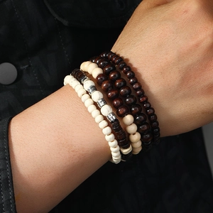 Close-up of handmade multi-layer beaded bracelet with natural wood and white stone beads
