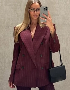 Detail of burgundy pinstripe double-breasted blazer with structured shoulder pads
