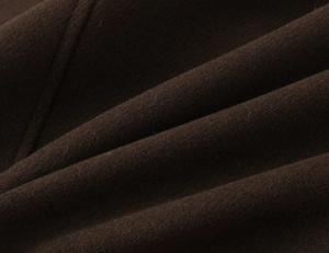 Detailed macro texture of heavy brown wool fabric for women's short double-breasted coat
