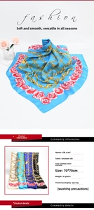 Detailed pattern of silk scarf with gold chains and red roses on blue base