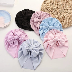 Infant waffle knit turban hats with decorative bows in various pastel colors