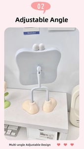 Detail of adjustable cartoon desktop mirror with eye decals and footed stand base