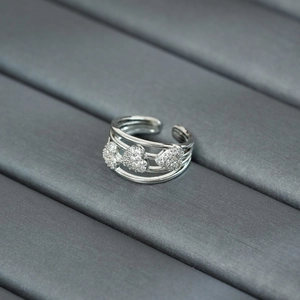Macro shot of silver adjustable triple-band ring with three heart-shaped zircon stones