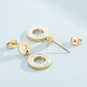Detail of gold double circle earrings with sparkling crystals and polished finish