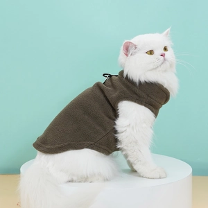 Detail view of brown fleece cat vest with sleeveless design on a fluffy white cat