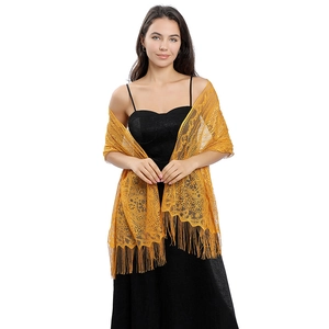 Detail of ginger yellow lace shawl featuring intricate floral patterns and long fringes