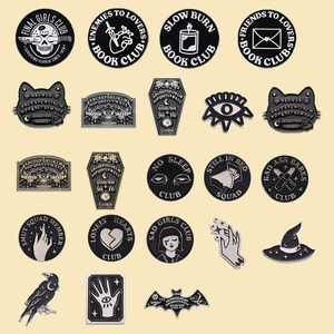 Gothic punk enamel pin set featuring black geometric fire and dark book club motifs