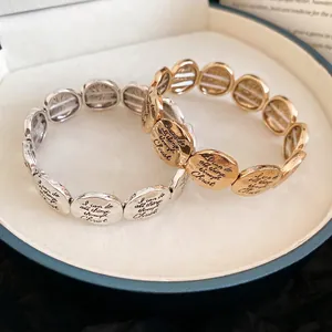 Metallic elastic bracelet with engraved religious quote in gold and silver finish