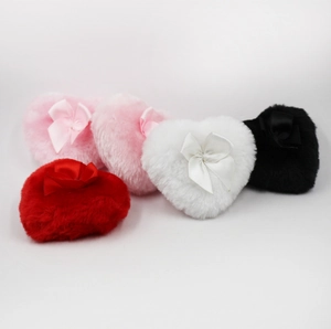 Detail of plush heart-shaped powder puffs in five colors with satin bow accents