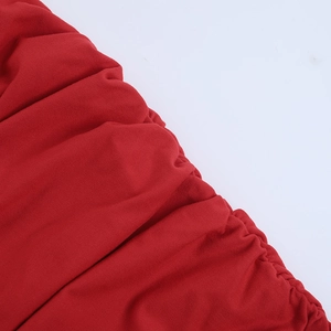 Close-up of red knitted fabric texture with elegant pleated details for beach set