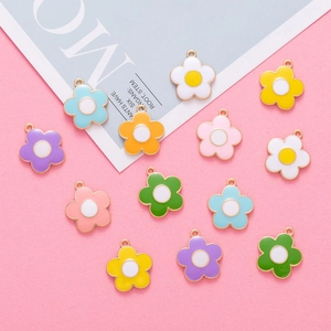 Detailed view of colorful flower enamel charms with gold-plated alloy edges and petals