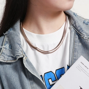 Close-up of double-layered gold flat snake chain necklace on model for daily styling