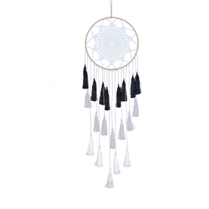 Handmade beige dreamcatcher with white crochet pattern and black gradient fringe tassels
