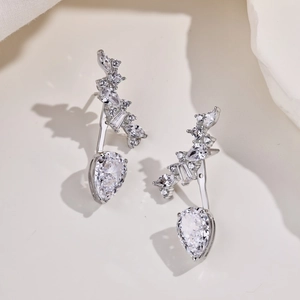 Detail of silver drop earrings with pear-cut zircon and radiant rhinestone accents