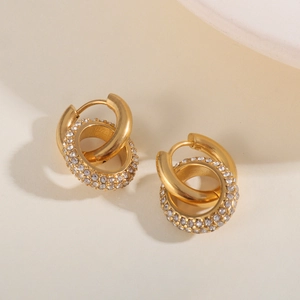 Detailed macro view of 18K gold-plated double hoop earrings with white zircon accents