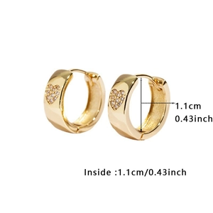 Detail view of gold huggie earrings showing the 1.1cm inner diameter and heart stones