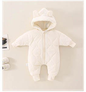 Detail of baby winter jumpsuit with cute bear ears hood and quilted wave pattern design