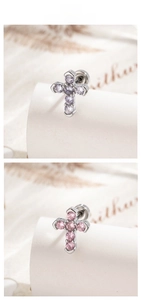 Detail showing micro-inlaid zircon cross earrings in purple and pink styles