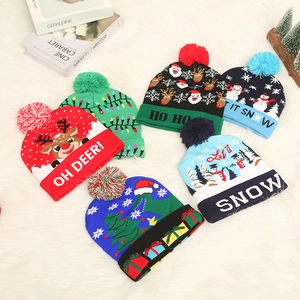 Collection of festive knitted Christmas hats with LED lights and colorful pom-poms