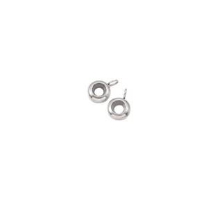 Macro shot of silver stainless steel hollow bead charms with a smooth polished finish