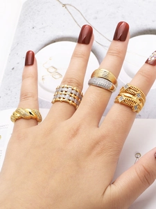Close-up of stacked gold and silver plated rings with zircon stones on model's hand