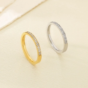 Macro view of gold and silver stainless steel rings with brushed texture and zircon stones