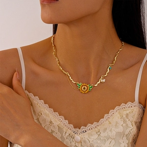 Detail of sunflower pendant with honey bee charm and turquoise bead on wavy chain